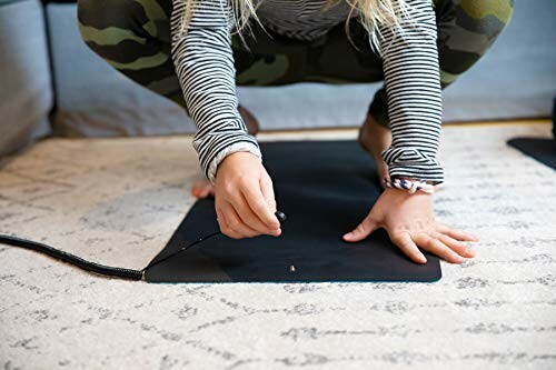 Person using a grounding mat on the floor